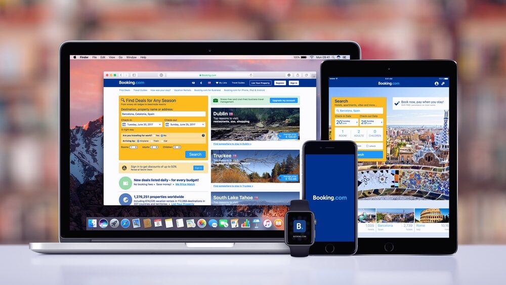 Booking.com hotels search page on the Apple MacBook Pro, Booking.com app on iPad Pro, Booking splash screen with logo on iPhone 7 and notification icon on Apple Watch.