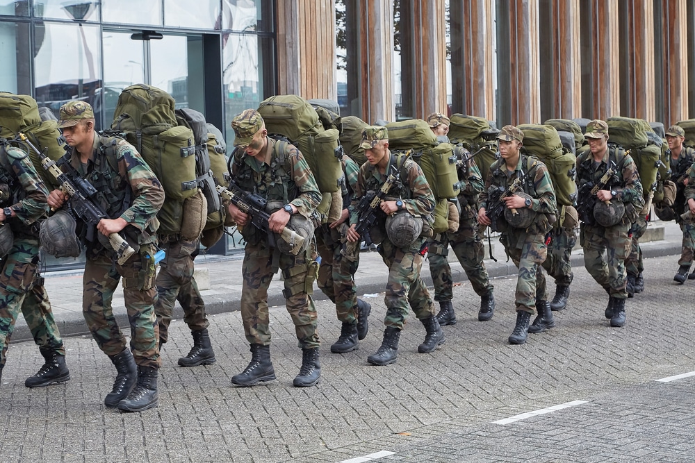 Rotterdam, The Netherlands - Circa 2019: Line of soldiers marching on a street on training